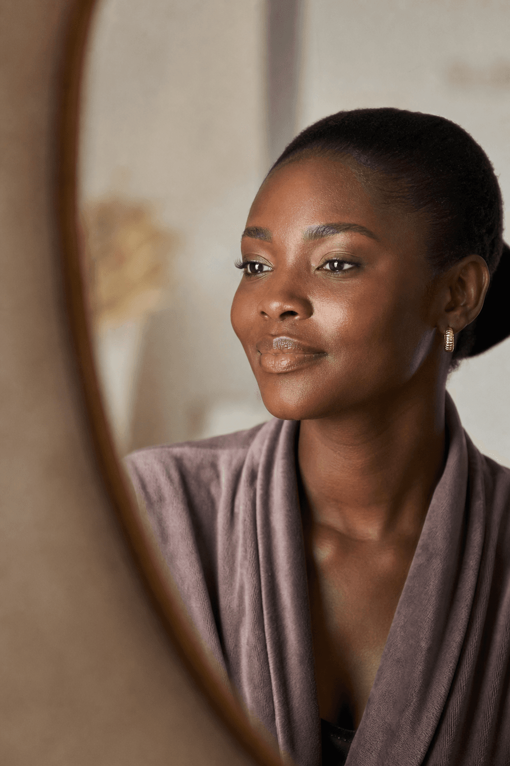 A woman enjoying a quiet, confident beauty moment